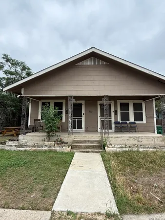 a front view of house with yard and porch