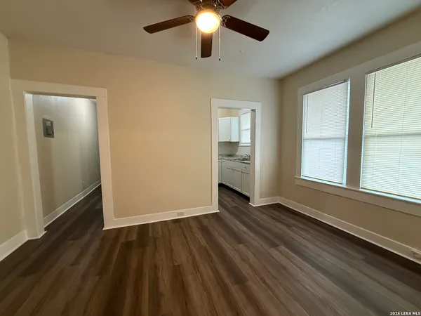 wooden floor in an empty room with a window