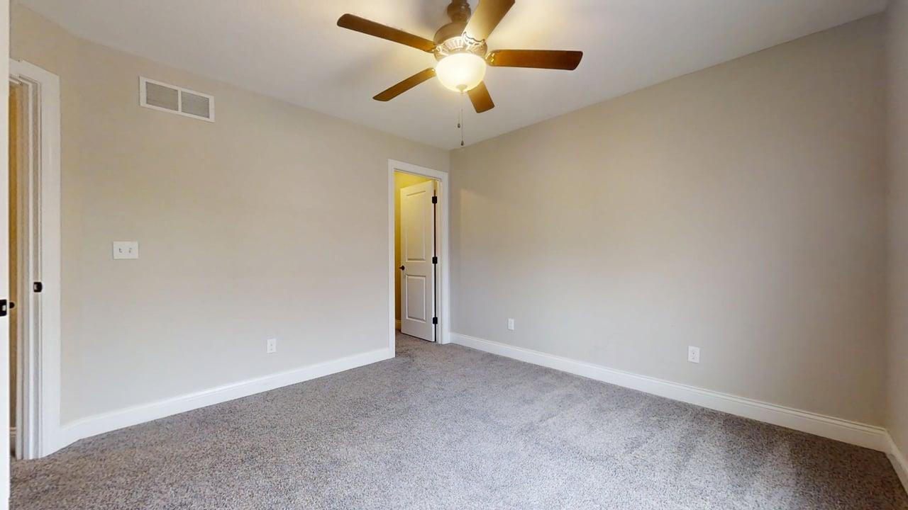 1318 Myrtle Beach Avenue Champaign, IL 61822 - Photo 17 of 29 an empty room with a ceiling fan and a window