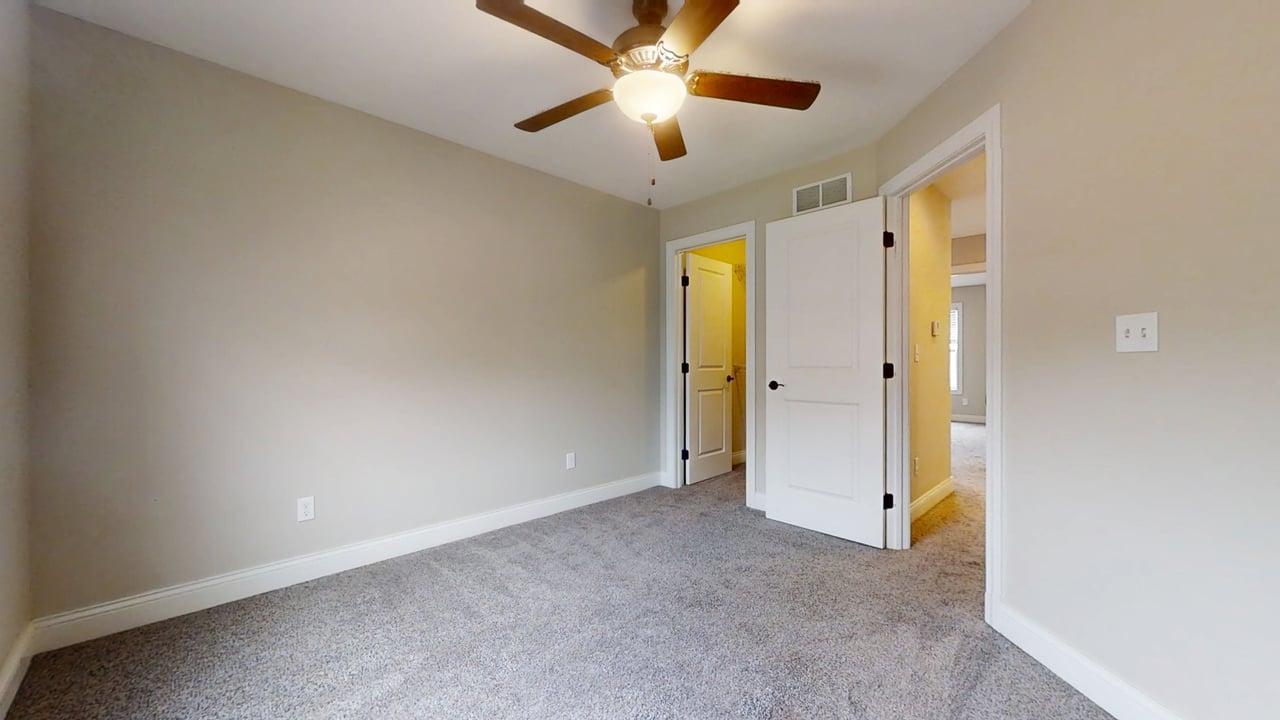 1318 Myrtle Beach Avenue Champaign, IL 61822 - Photo 21 of 29 a view of an empty room and a ceiling fan