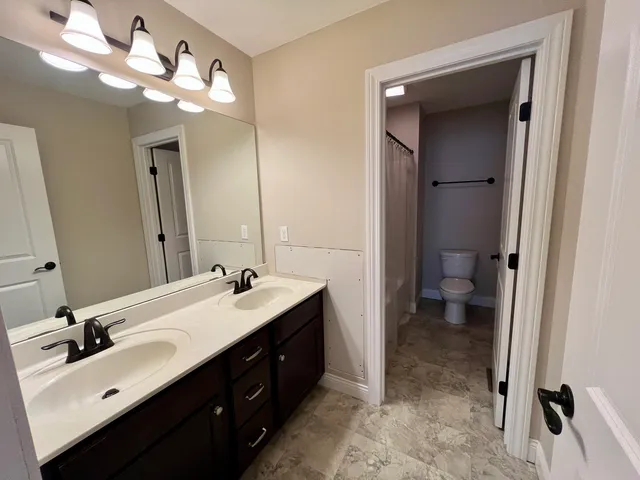 a white toilet sitting next to a white sink