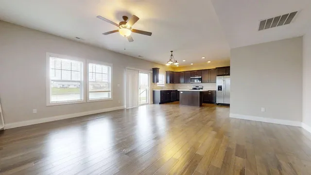 a view of kitchen with furniture and wooden floor