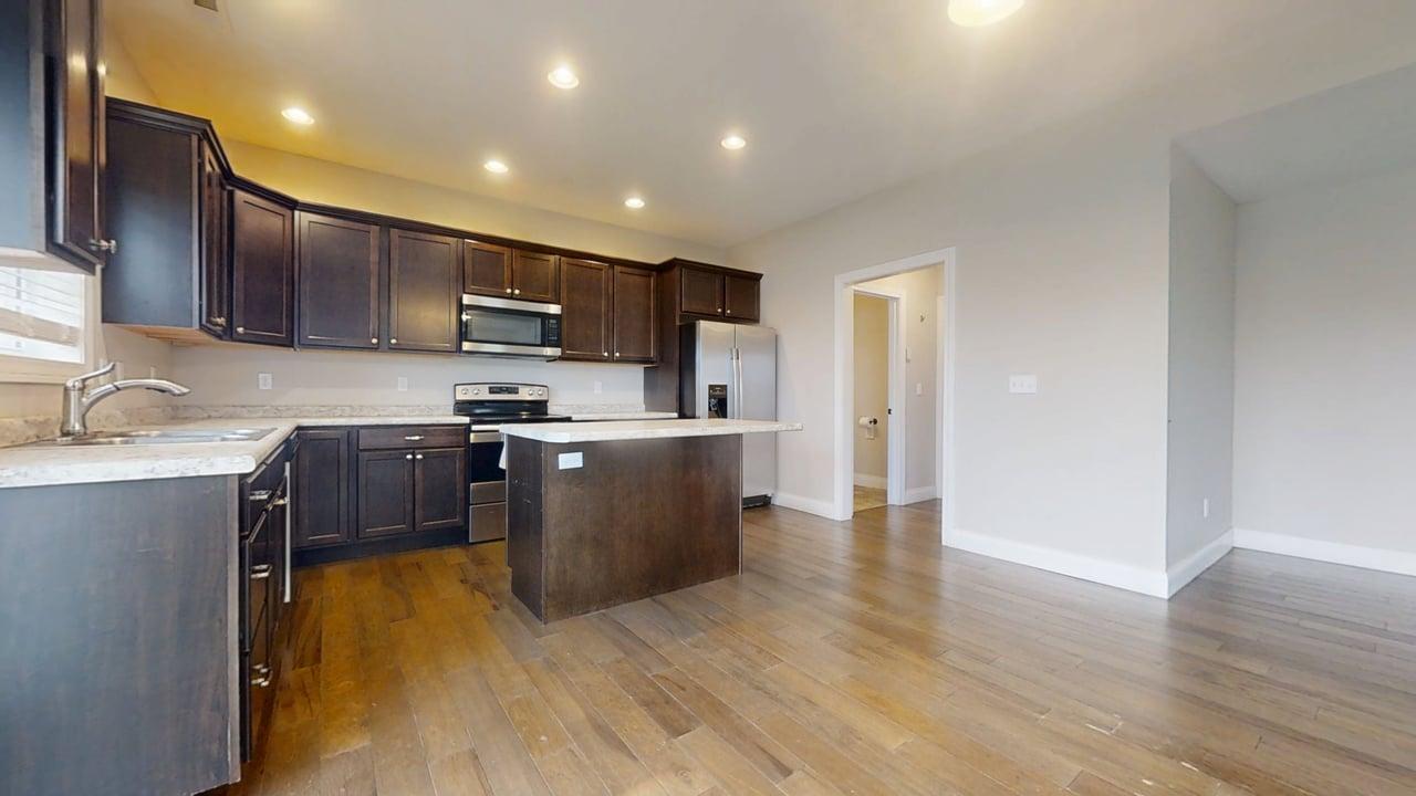 1318 Myrtle Beach Avenue Champaign, IL 61822 - Photo 7 of 29 a kitchen with stainless steel appliances granite countertop white cabinets a sink a stove a refrigerator and a microwave