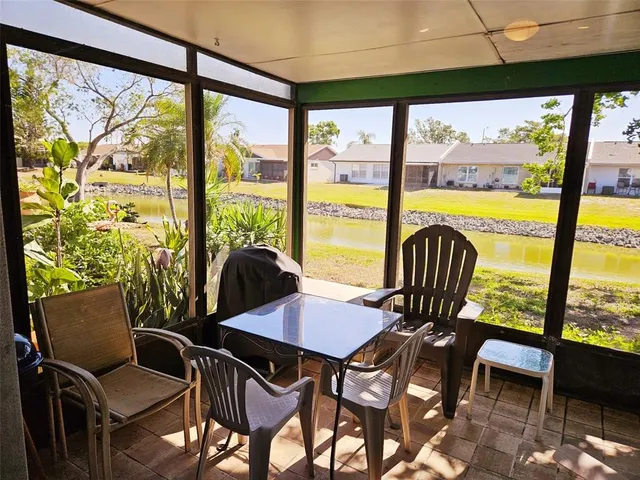 a view of a dining room with furniture large windows and wooden floor