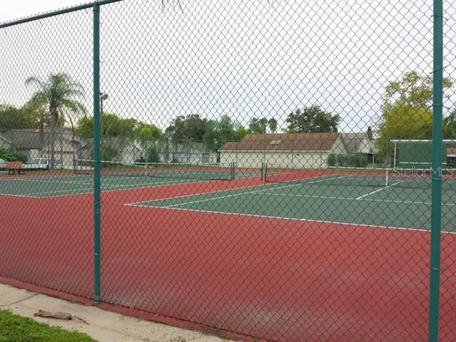 a view of a green field with wooden fence