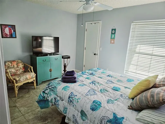 a bedroom with a bed and a television