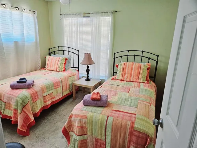 a bedroom with bed and a window