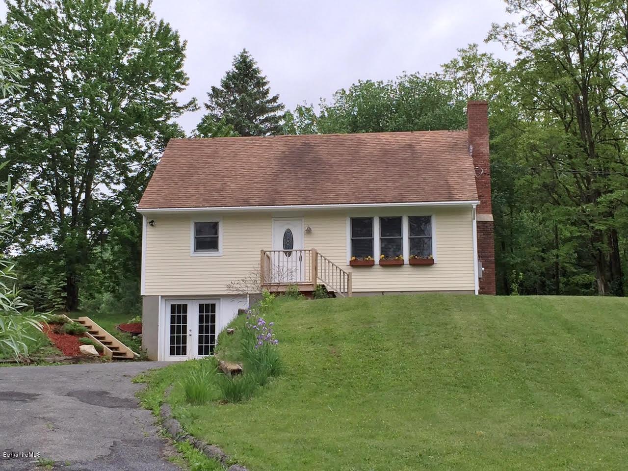 187 Swamp Road Richmond, MA 01201 - Photo 1 of 27 a front view of a house with a garden