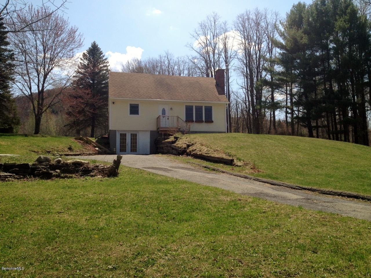 187 Swamp Road Richmond, MA 01201 - Photo 2 of 27 a view of a house with a yard covered with snow in the background