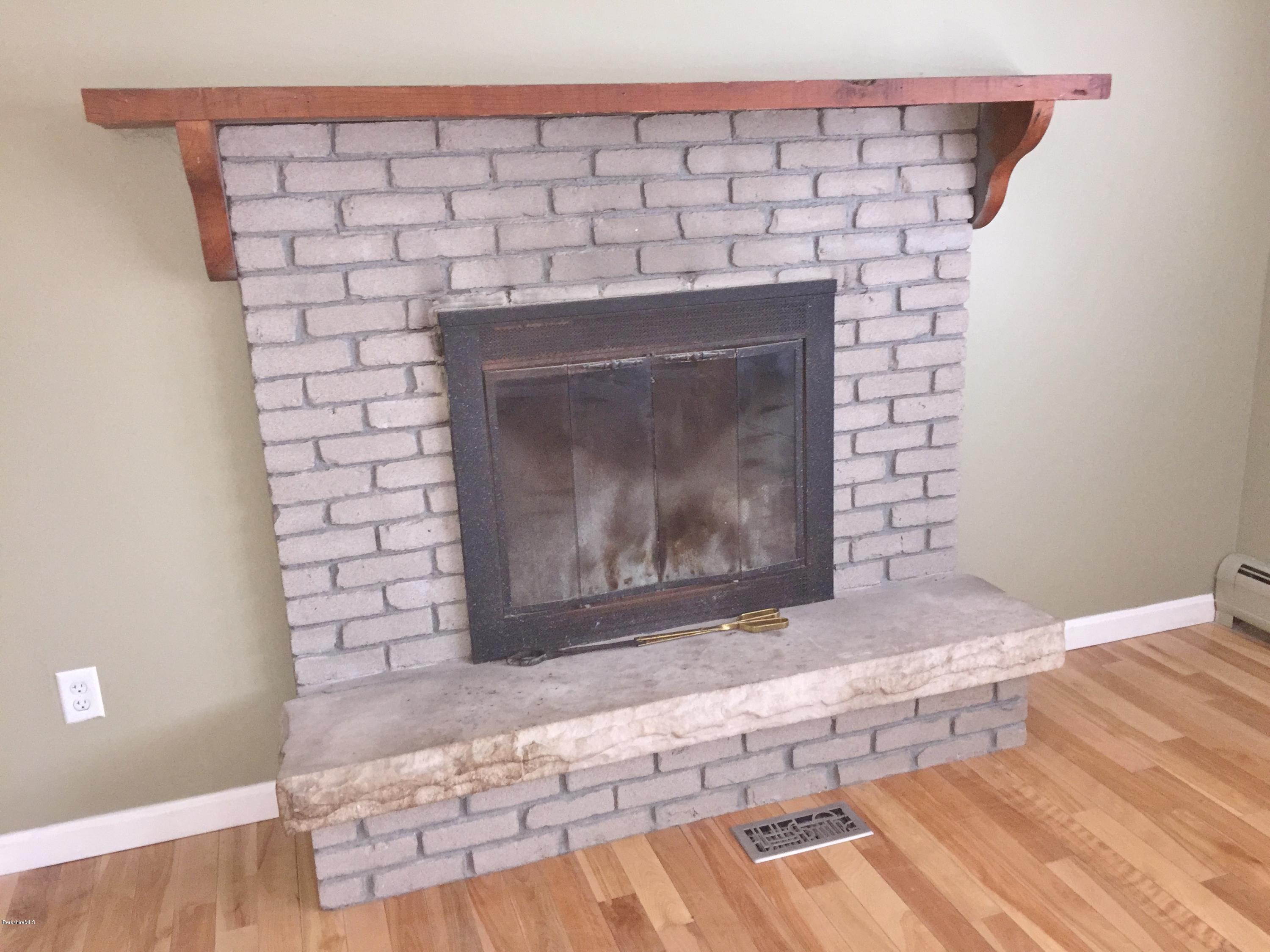 187 Swamp Road Richmond, MA 01201 - Photo 11 of 27 a fireplace with wooden floor
