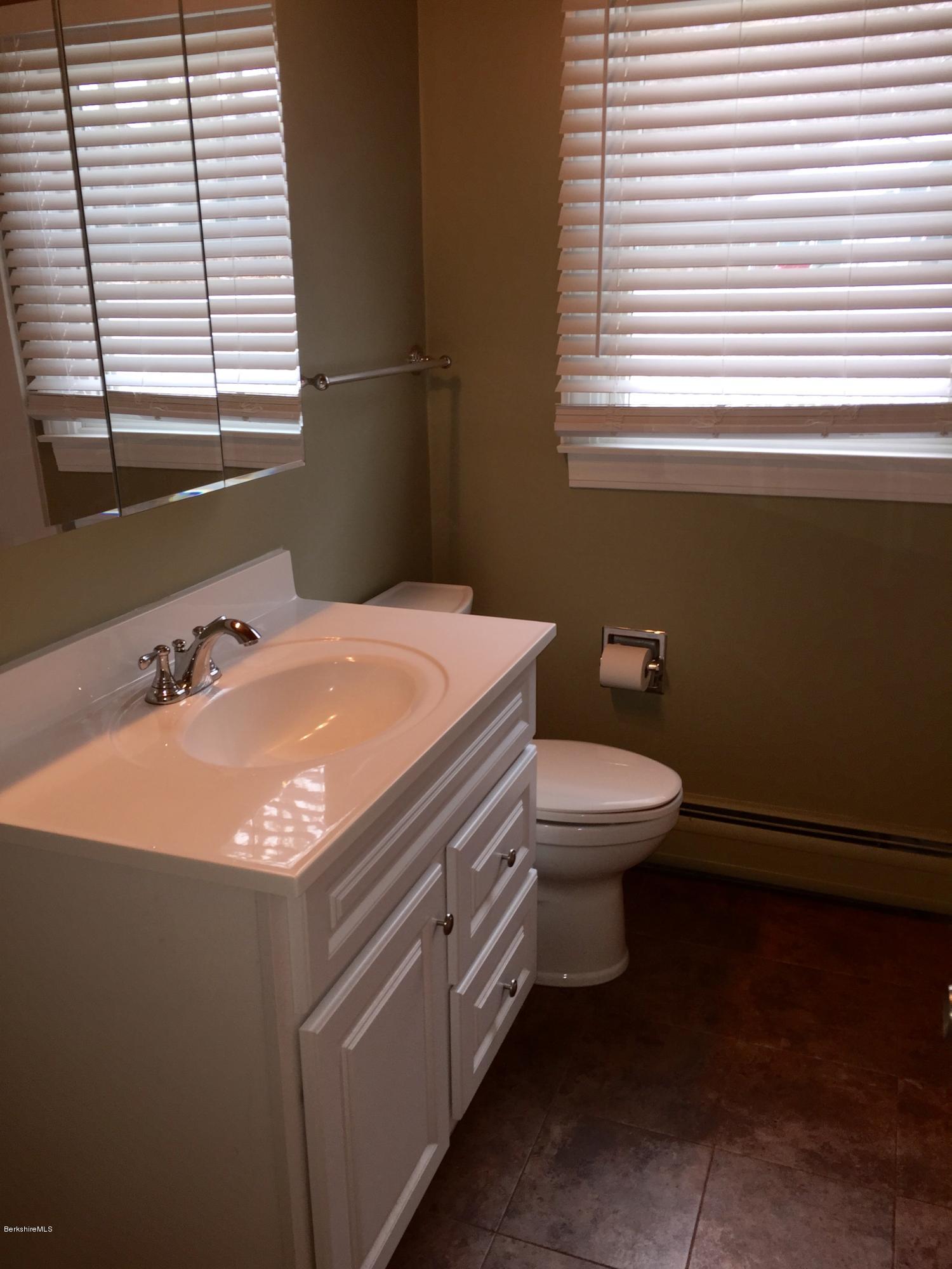 187 Swamp Road Richmond, MA 01201 - Photo 12 of 27 a bathroom with a sink a toilet and a window