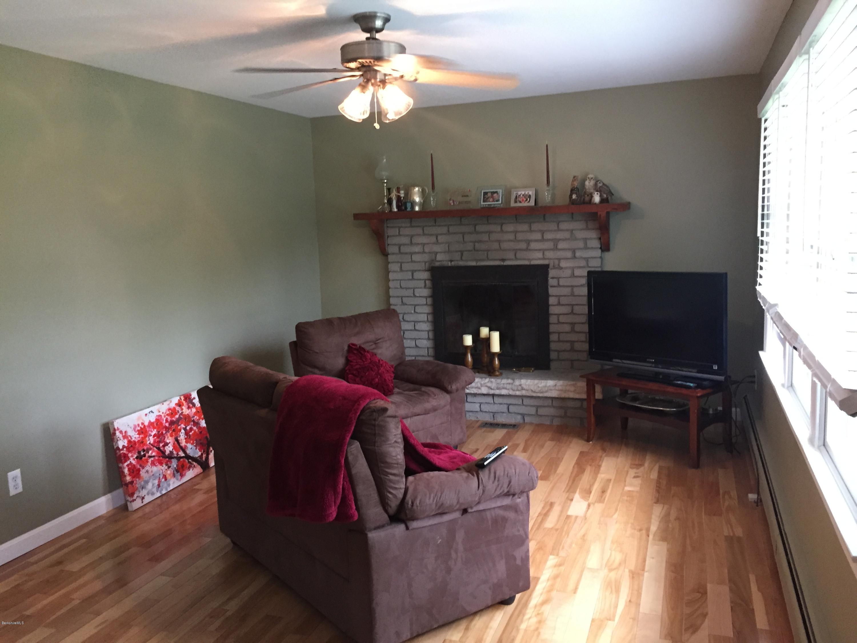 187 Swamp Road Richmond, MA 01201 - Photo 22 of 27 a living room with furniture and a fireplace