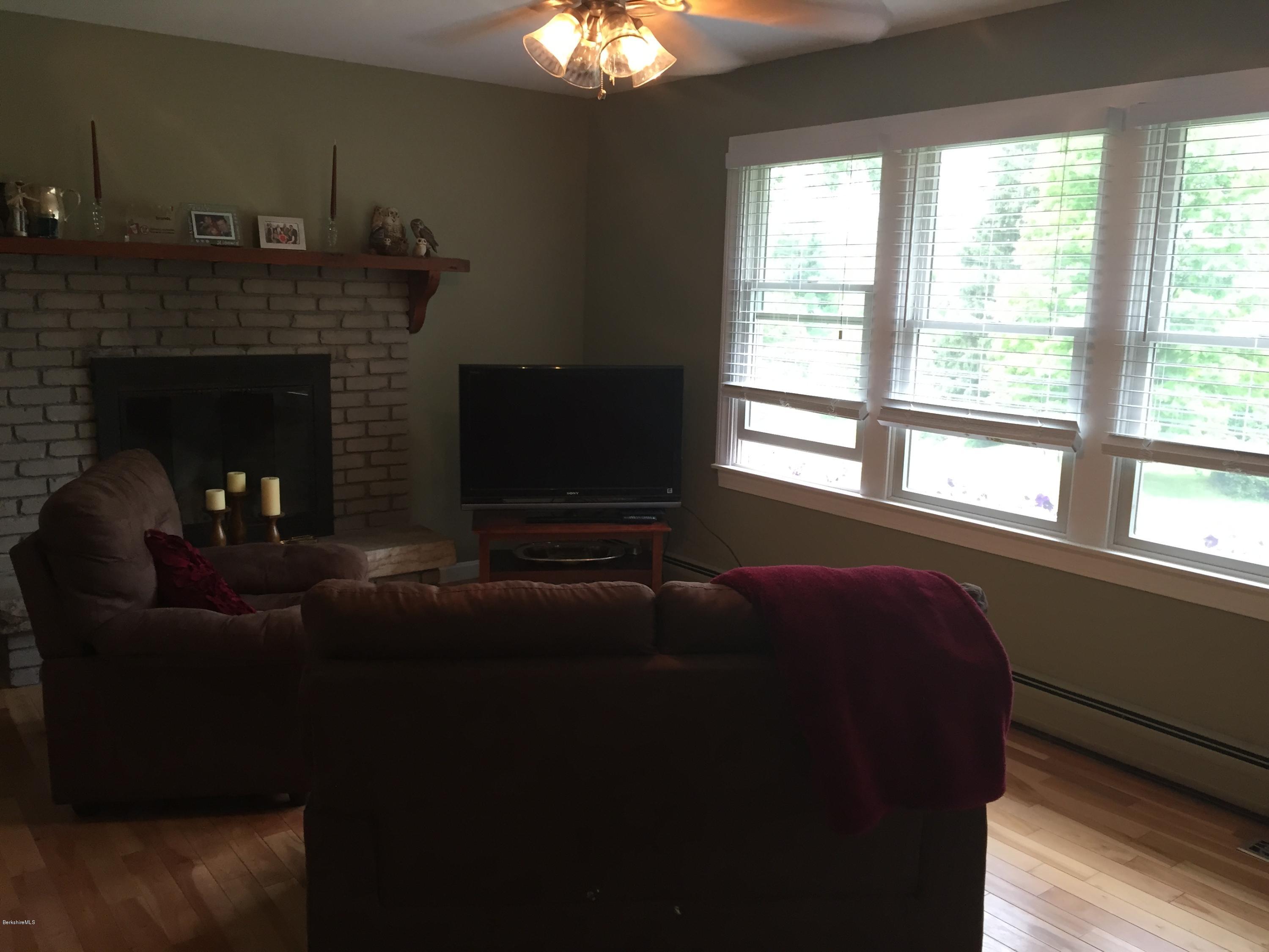 187 Swamp Road Richmond, MA 01201 - Photo 23 of 27 a living room with furniture and a fireplace