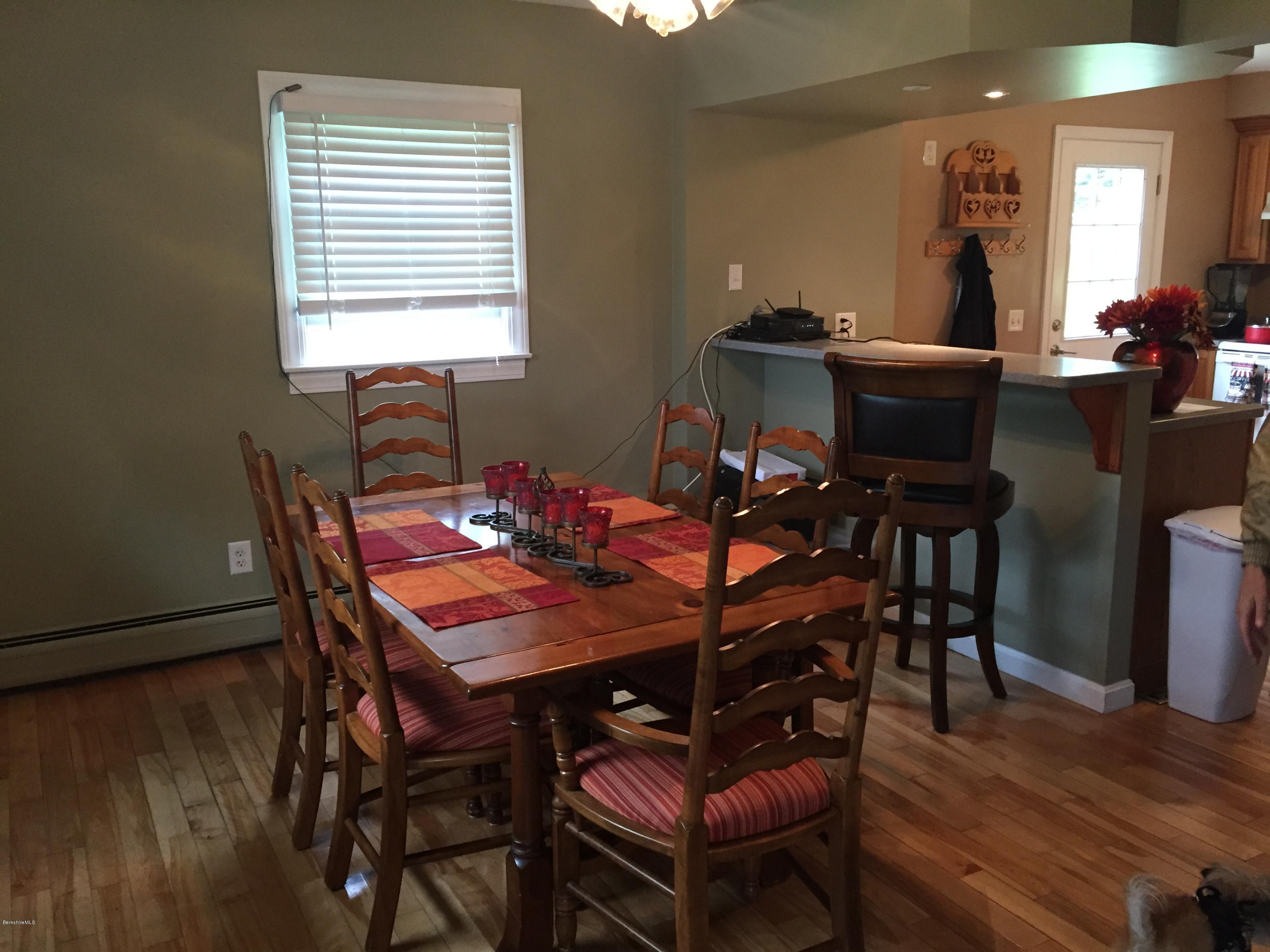 187 Swamp Road Richmond, MA 01201 - Photo 24 of 27 a dining room with furniture and wooden floor