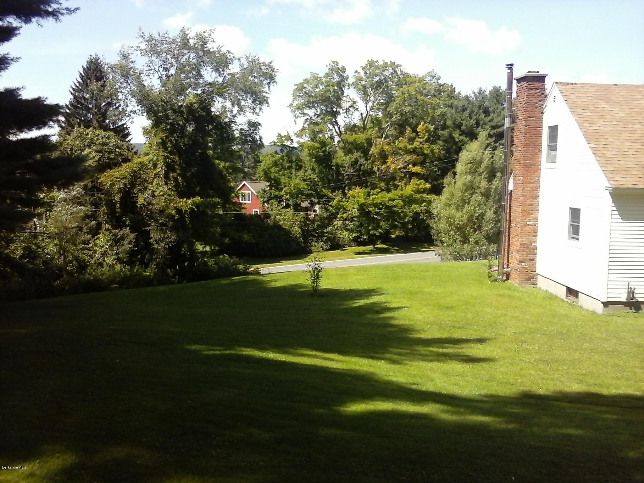 187 Swamp Road Richmond, MA 01201 - Photo 4 of 27 a view of a golf course with a lake