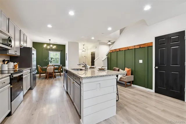 a kitchen with a sink appliances and cabinets