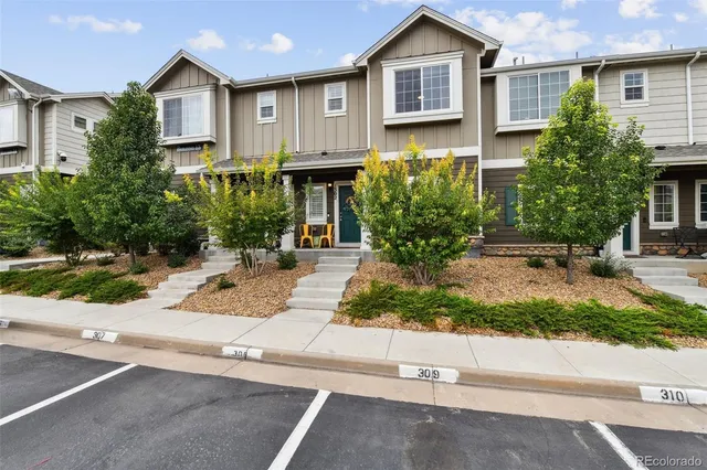 a view of a house with a yard and plants