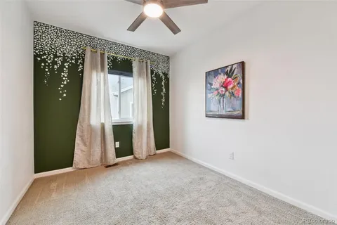 an empty room with a fireplace and fan