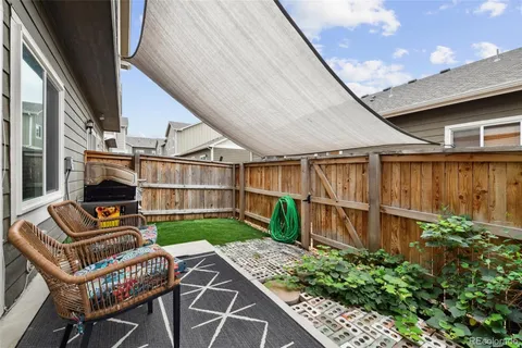 a view of backyard with seating space and stairs
