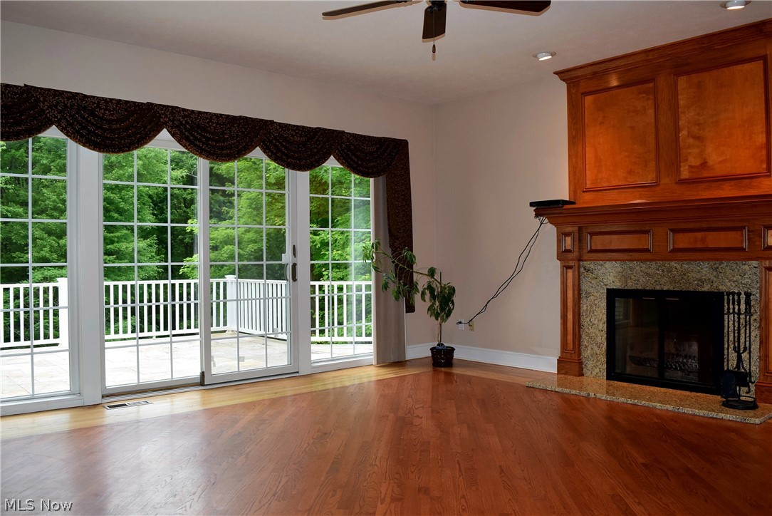 17000 Wing Road Chagrin Falls, OH 44023 - Photo 10 of 35 This Family Room view reveals a 12' wide glass wall with a sliding door to the unique upper stone deck (18' x 16') overlooking the inground heated salt water pool with additional steps thru the lower stone deck (13' x 11').