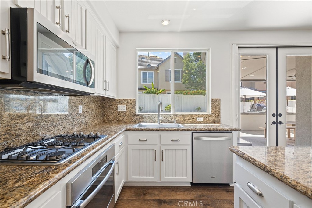 8 Danbury Ladera Ranch, CA 92694 - Photo 18 of 57 a kitchen with a sink stove and cabinets