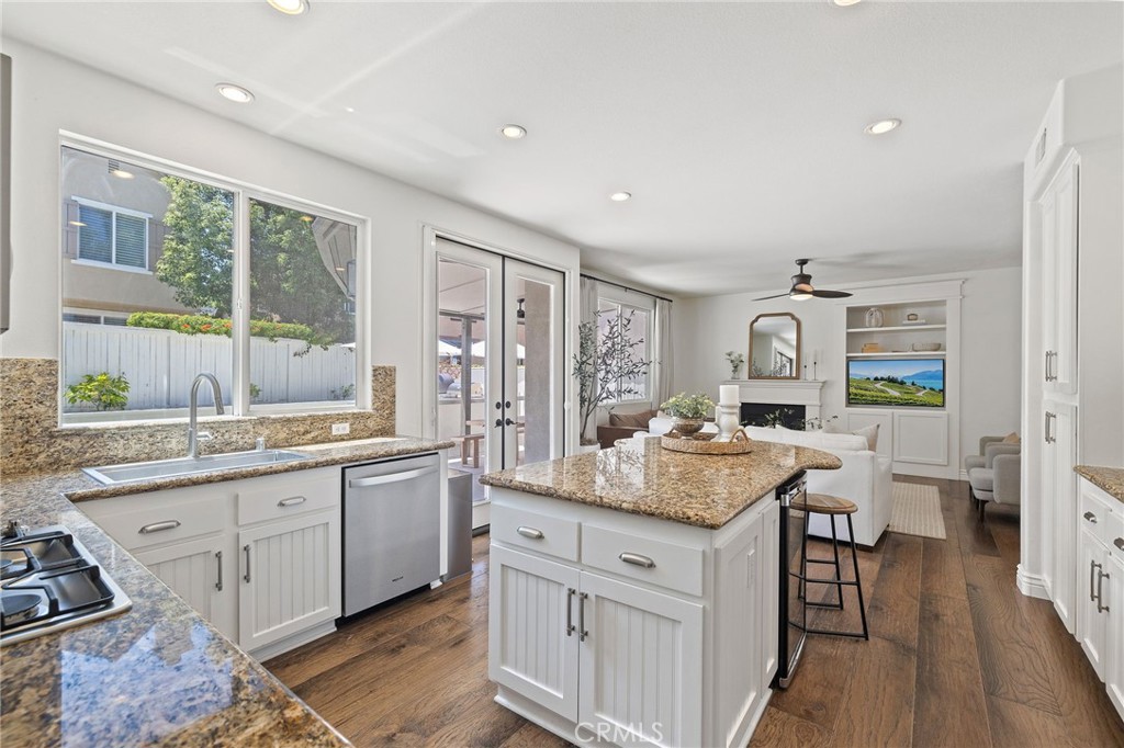 8 Danbury Ladera Ranch, CA 92694 - Photo 19 of 57 a kitchen with center island and living room