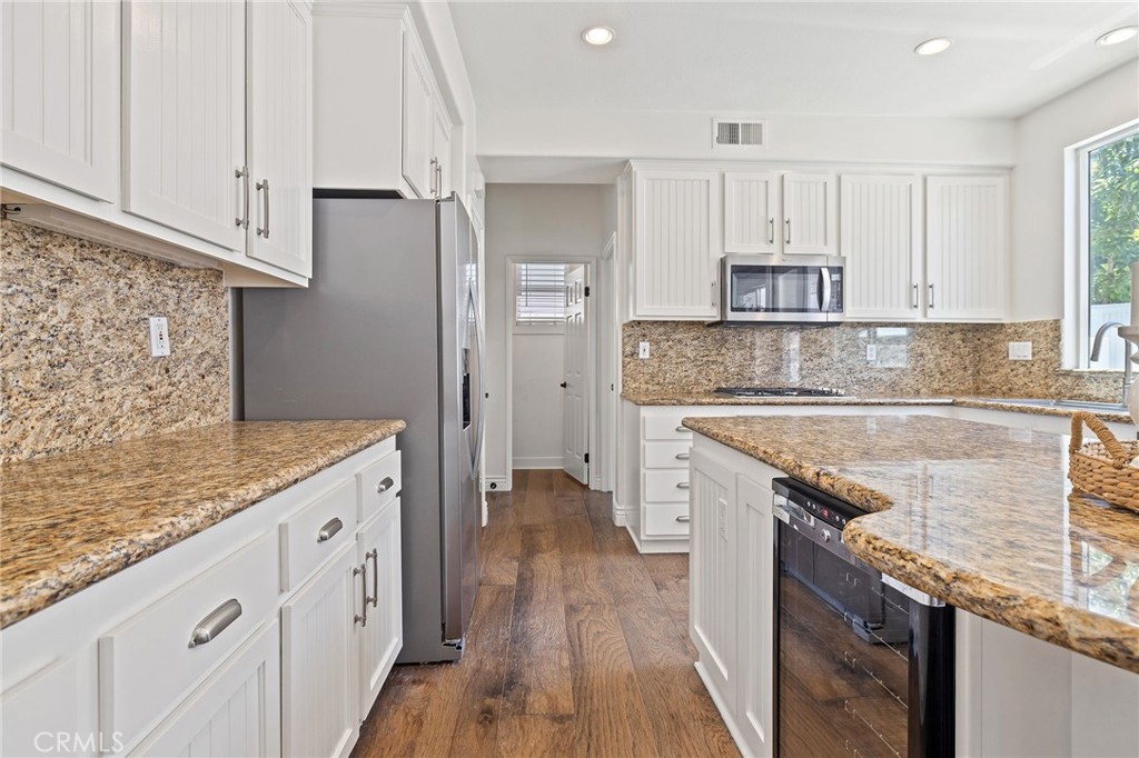 8 Danbury Ladera Ranch, CA 92694 - Photo 21 of 57 a kitchen with granite countertop a sink stove and cabinets