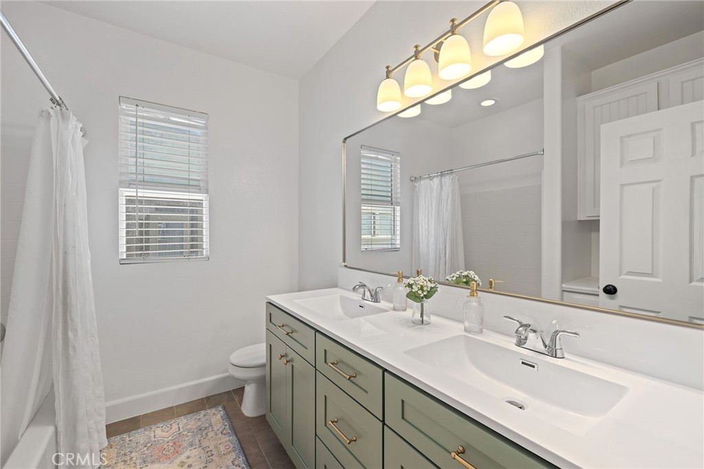 8 Danbury Ladera Ranch, CA 92694 - Photo 24 of 57 a bathroom with a sink a toilet and a mirror