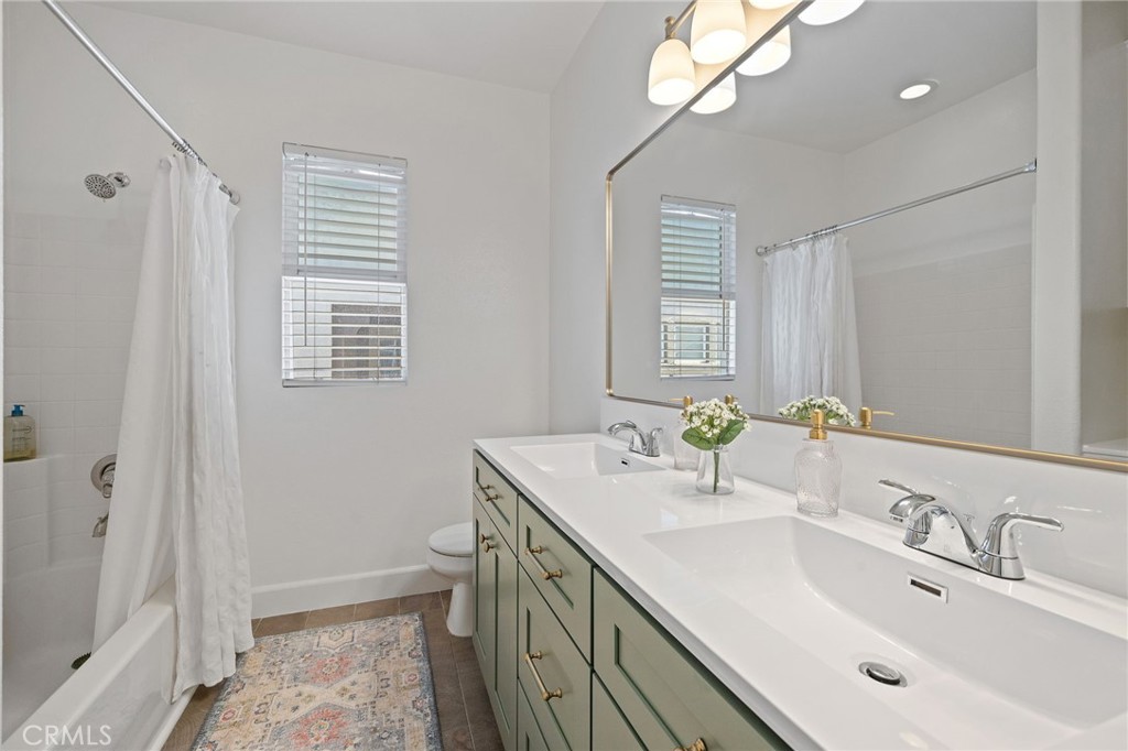8 Danbury Ladera Ranch, CA 92694 - Photo 25 of 57 a bathroom with a sink a vanity and a mirror