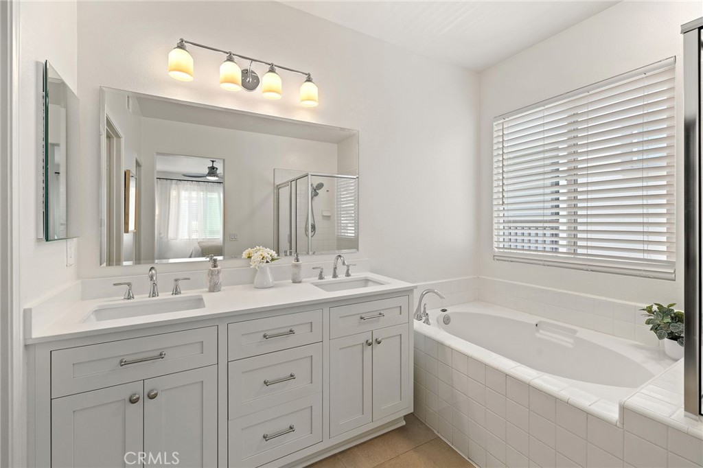 8 Danbury Ladera Ranch, CA 92694 - Photo 35 of 57 a bathroom with a bathtub a double vanity sink and mirror