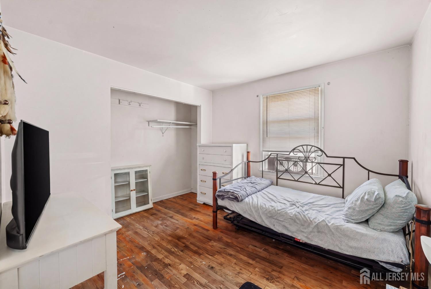 245 4th Street Dunellen, NJ 08812 - Photo 14 of 27 a bedroom with furniture and a flat screen tv