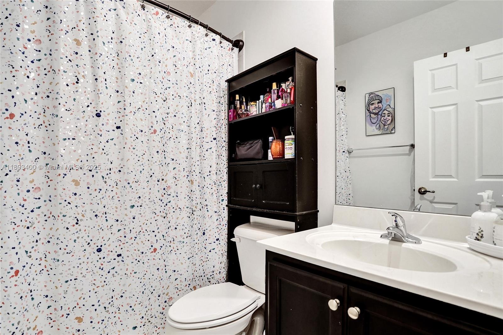 1832 Southwest 89th Terrace Miramar, FL 33025 - Photo 13 of 28 a bathroom with a sink a toilet and a mirror