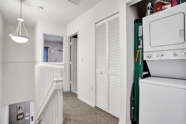a view of a hallway with washer and dryer