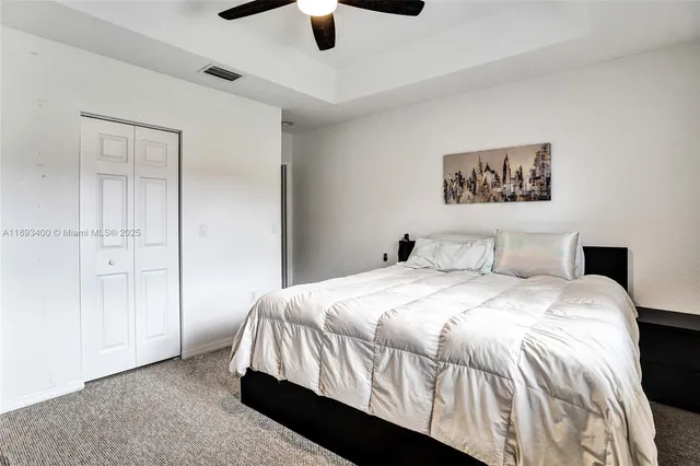 a bedroom with a bed and painting on the wall