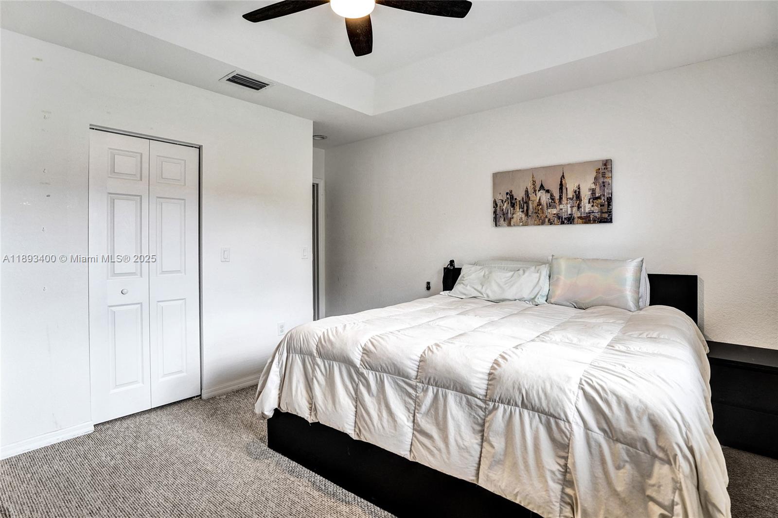 1832 Southwest 89th Terrace Miramar, FL 33025 - Photo 20 of 28 a bedroom with a bed and painting on the wall