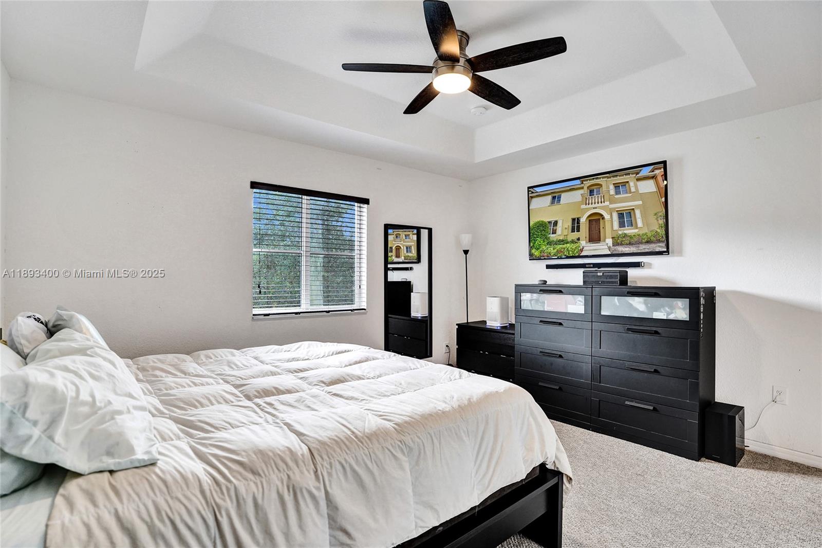 1832 Southwest 89th Terrace Miramar, FL 33025 - Photo 21 of 28 a bedroom with a bed and a flat tv screen on dresser