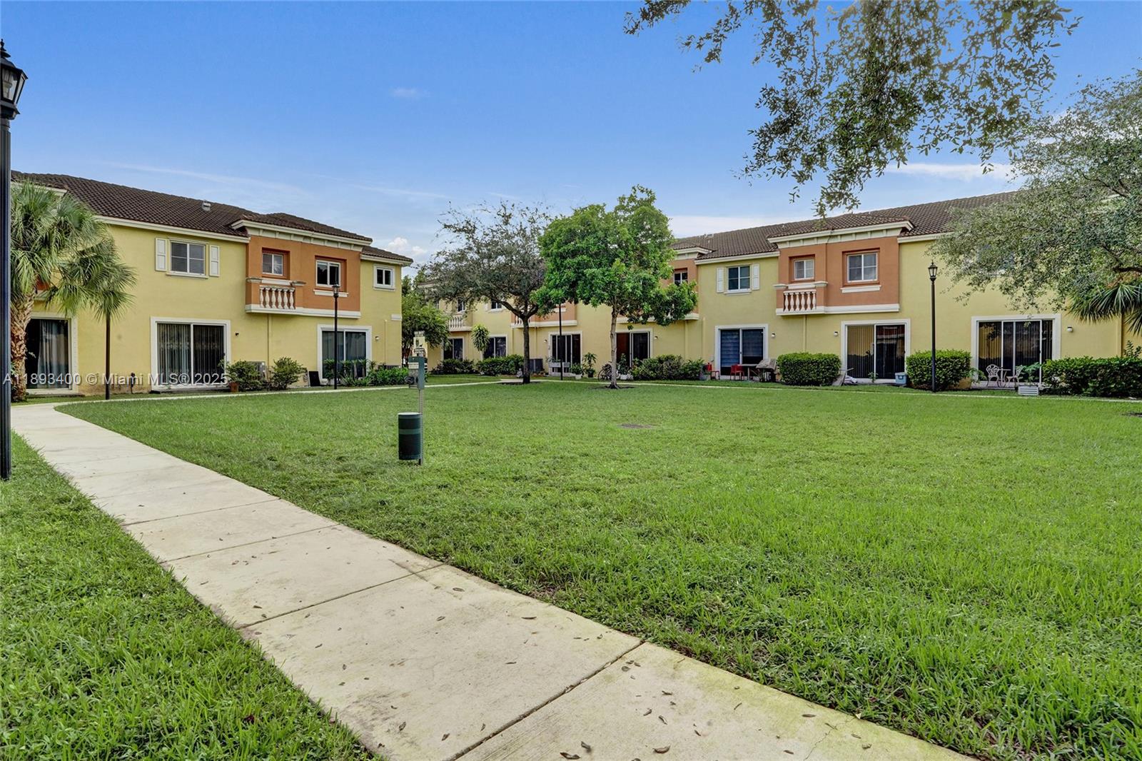 1832 Southwest 89th Terrace Miramar, FL 33025 - Photo 24 of 28 a view of a white house in front of a big yard with large trees