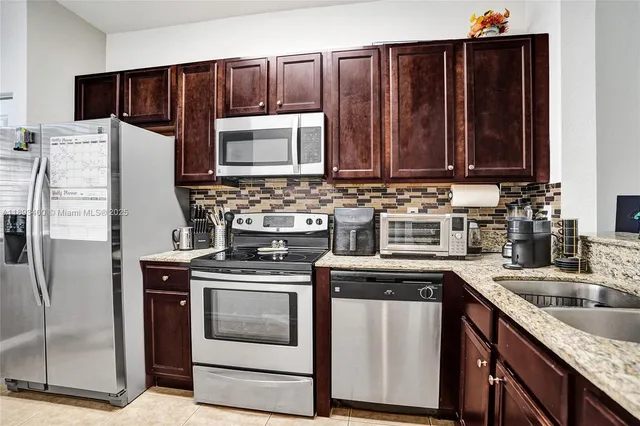 a kitchen with a sink stove and refrigerator