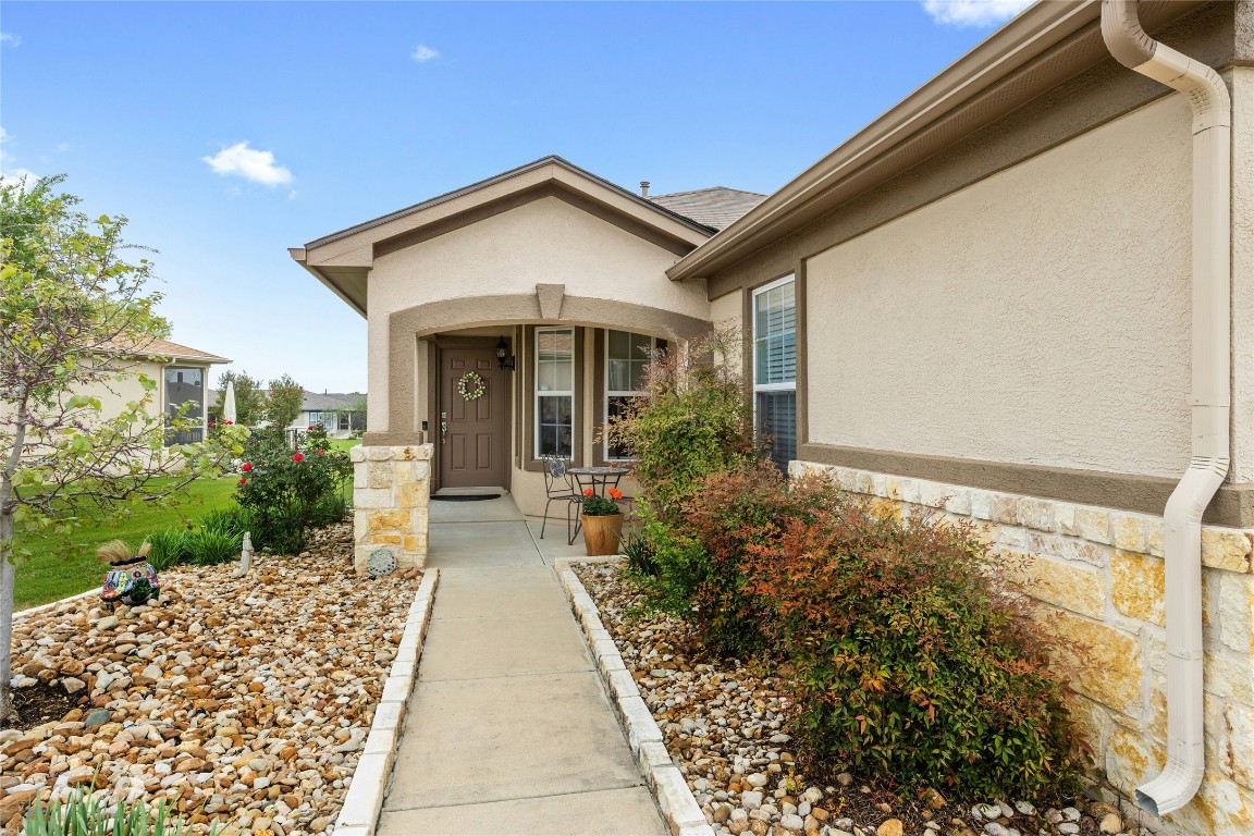 104 Monument Hill Trail Georgetown, TX 78633 - Photo 2 of 27 a view of a house with a small yard plants and large tree