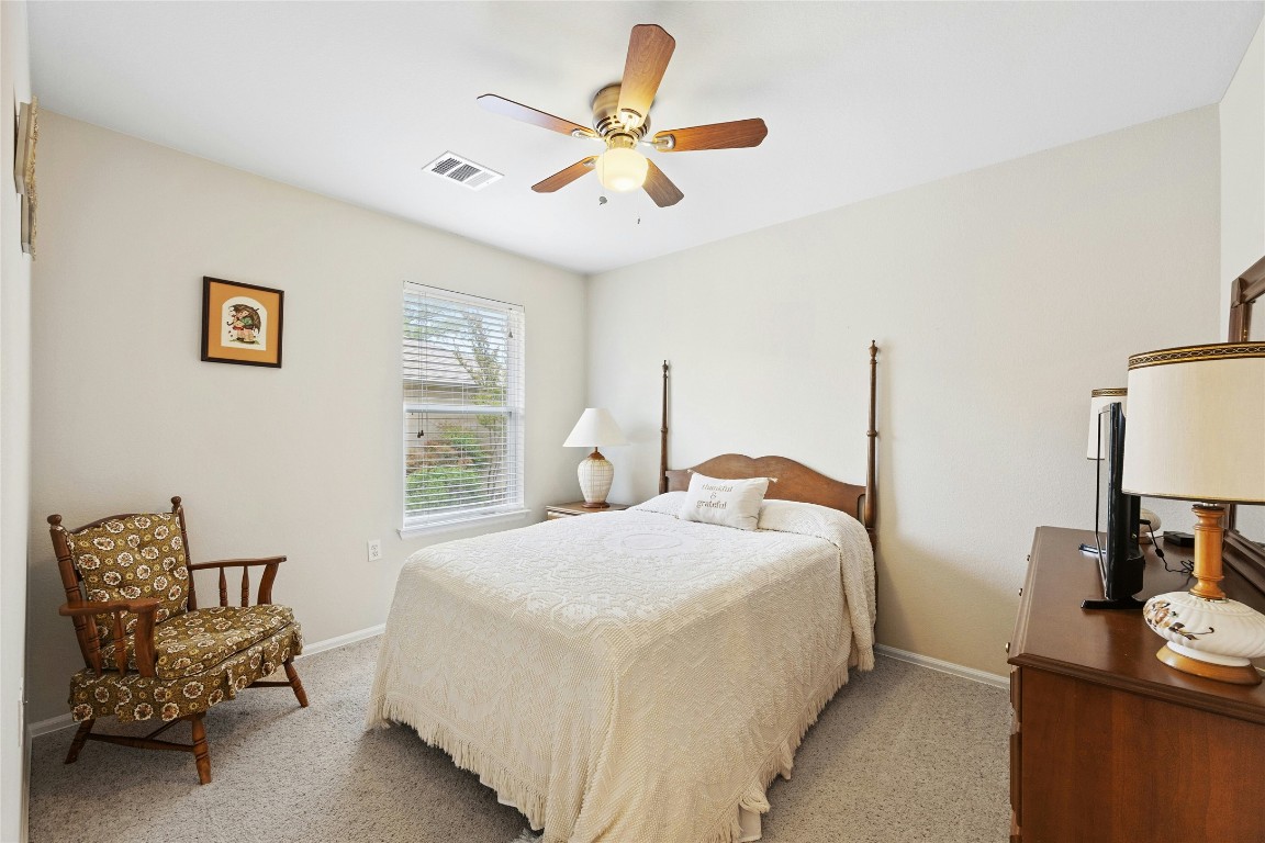 104 Monument Hill Trail Georgetown, TX 78633 - Photo 20 of 27 a bedroom with a bed and a chair