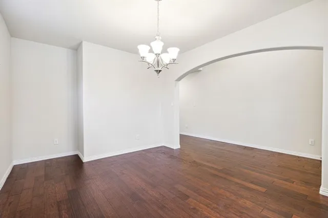 a view of a chandelier fan and wooden floor
