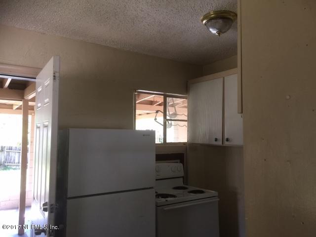 1427 King Arthur Road Jacksonville, FL 32211 - Photo 24 of 37 a room with a window and a refrigerator
