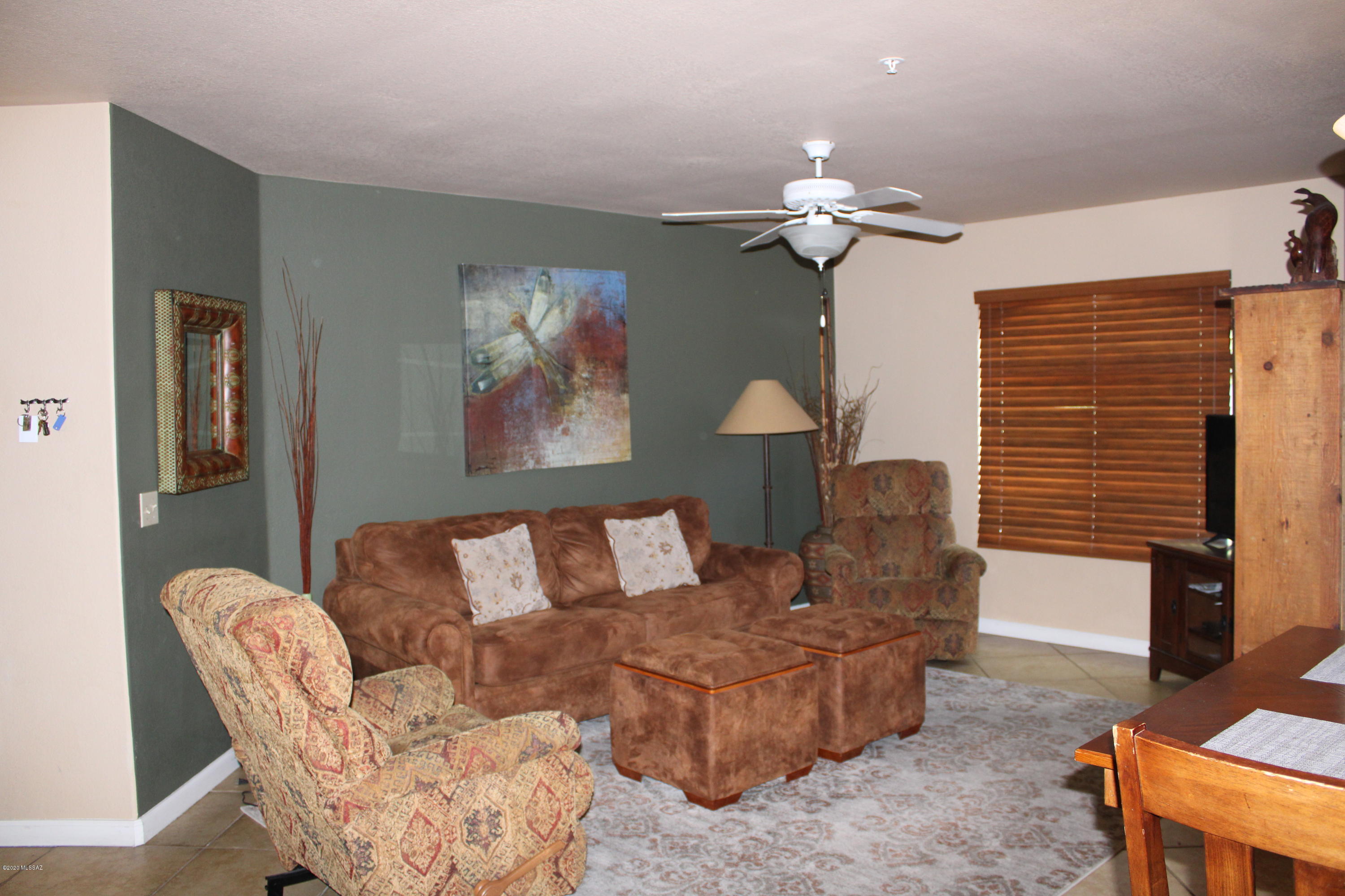 5751 North Kolb Road, Unit 36203 Tucson, AZ 85750 - Photo 5 of 25 a living room with furniture a chandelier and a window