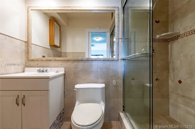 a bathroom with a toilet sink and shower