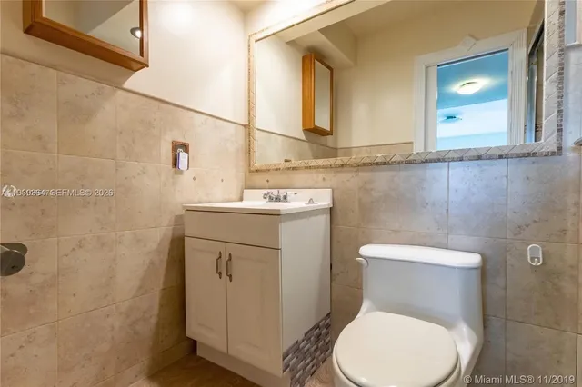 a white toilet sitting next to a bathroom sink