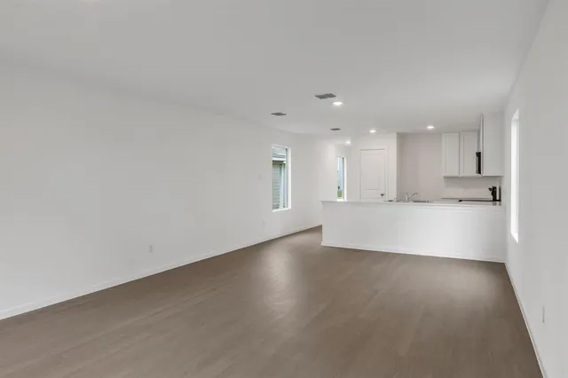 an empty room with a empty space and windows