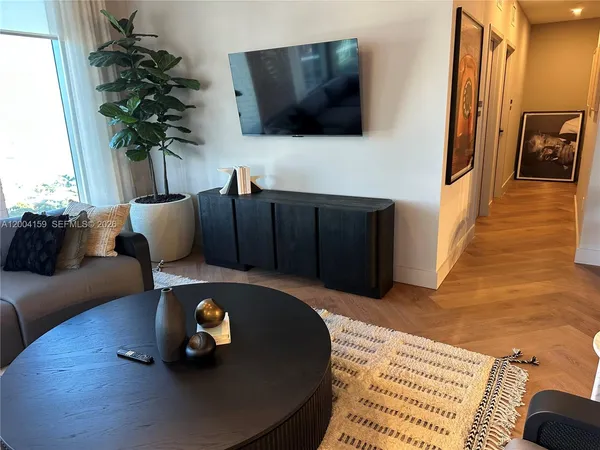 a living room with furniture and a large window