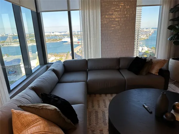 a living room with blue lights with furniture