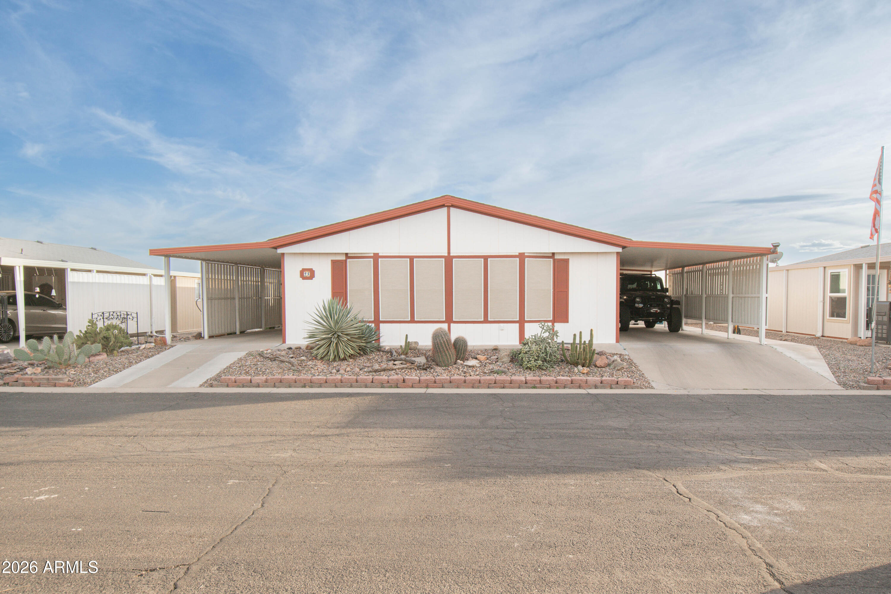 3700 South Tomahawk Road, Unit 95 Apache Junction, AZ 85119 - Photo 1 of 31 a view of a house with a yard and a garage