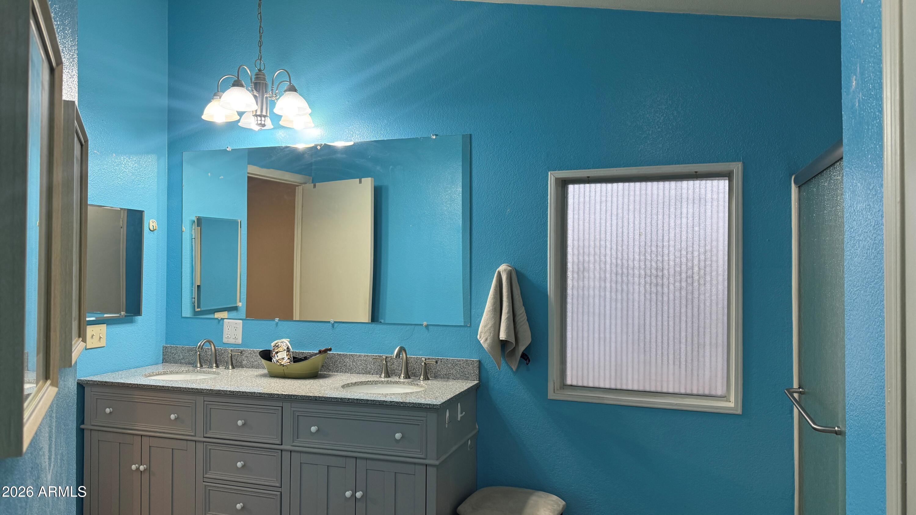 3700 South Tomahawk Road, Unit 95 Apache Junction, AZ 85119 - Photo 13 of 31 a bathroom with a double vanity sink and a mirror